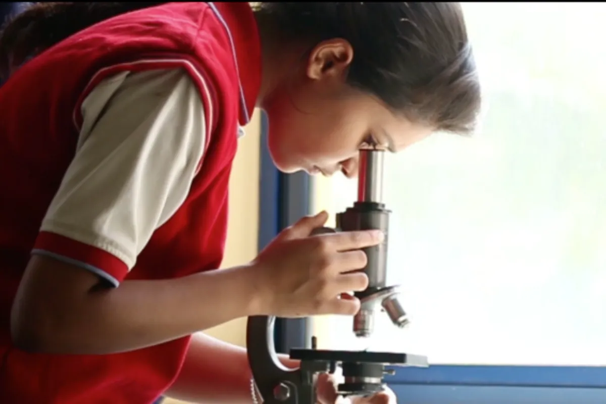 Student Seeing Through Microscope
